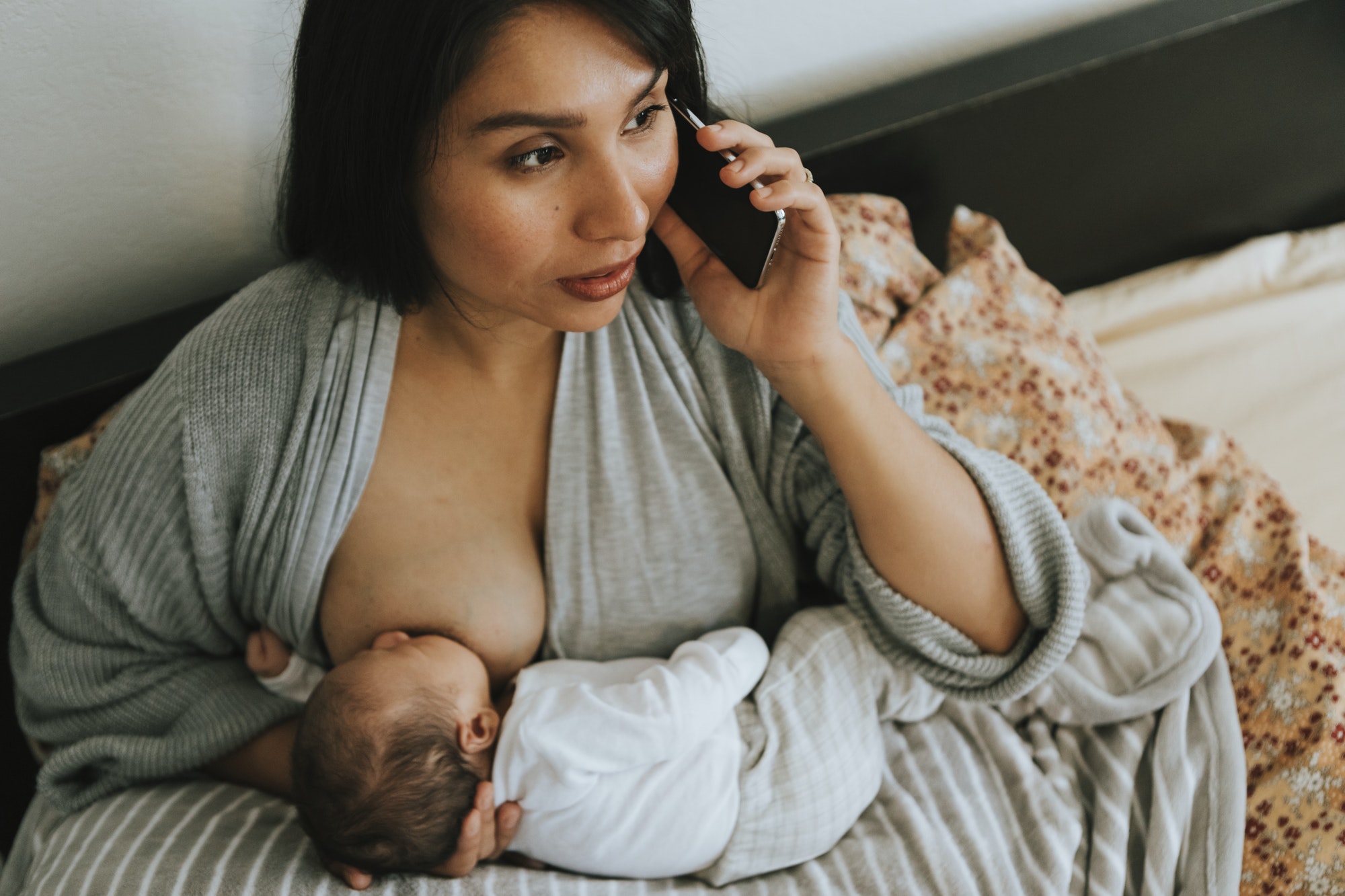 Mother breastfeeding while on the phone