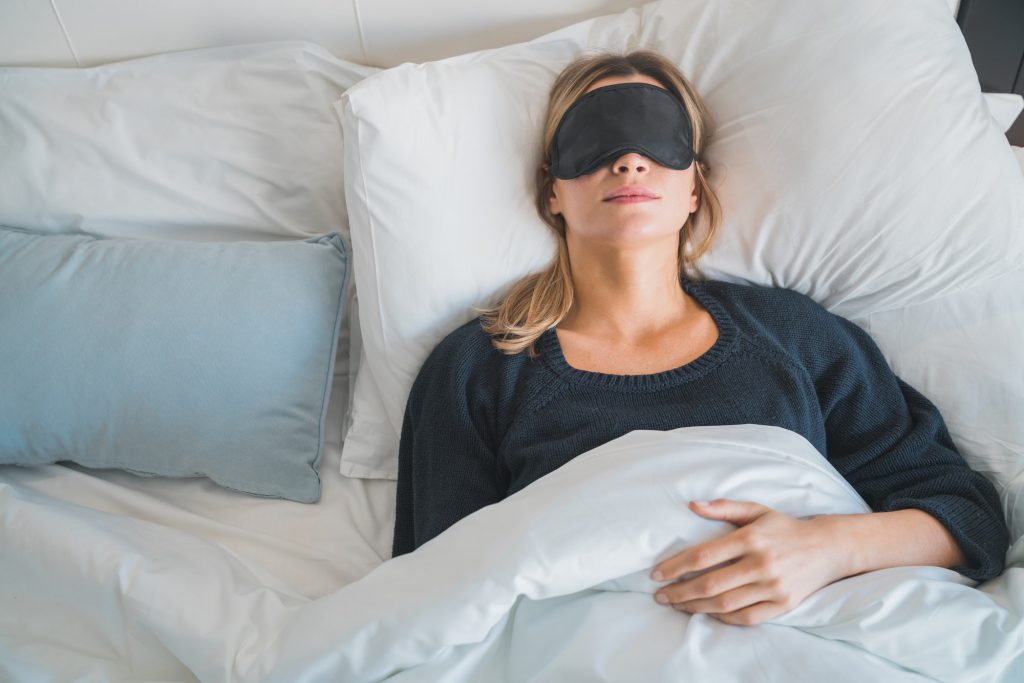 Woman sleeping with sleep mask.