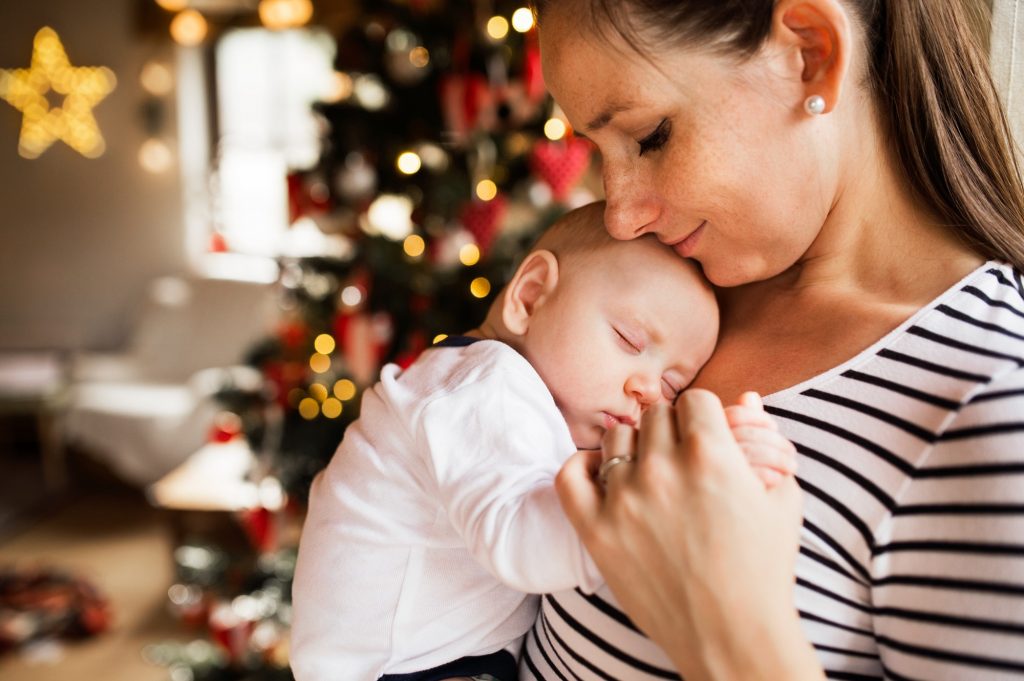 Young woman with a baby boy at Christmas time.