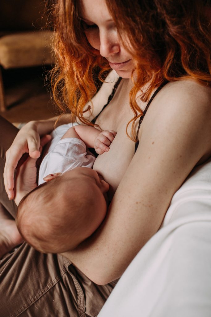 breastfeeding mama with red hair