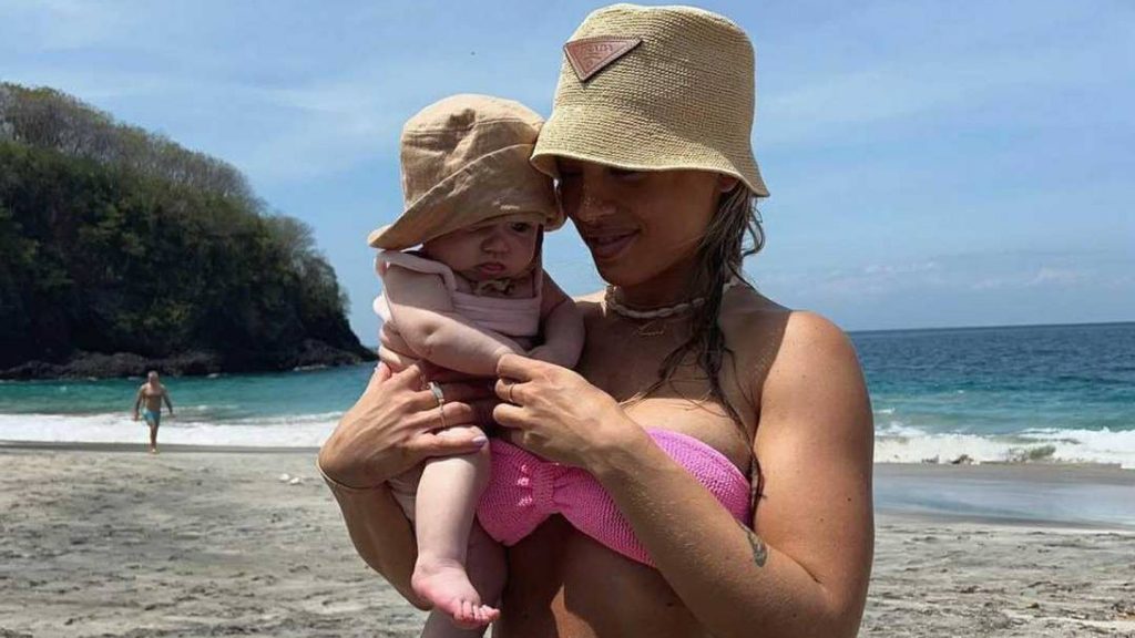Tammy Hembrow and baby on beach