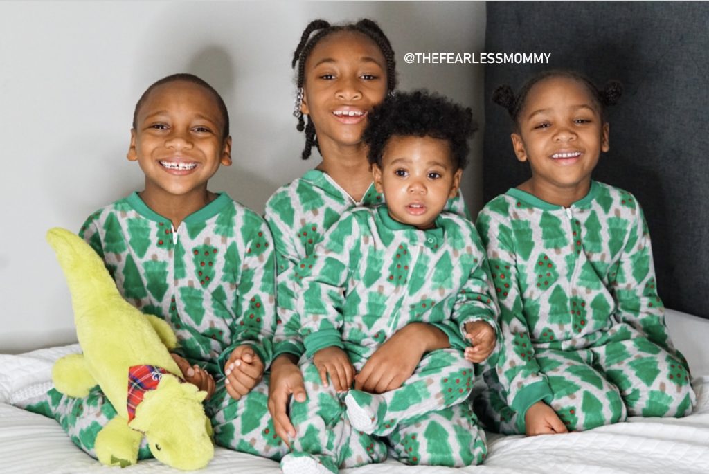 Four black children in pajamas from childrens place on Christmas 