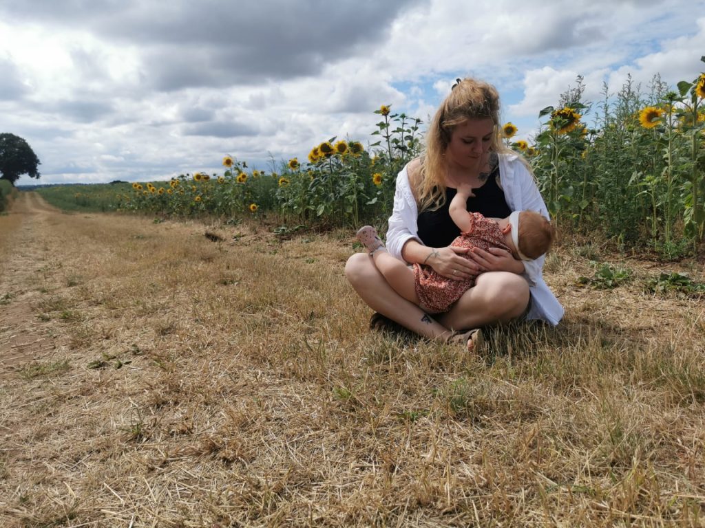 Breastfeeding by the sunflowers - April Robson
