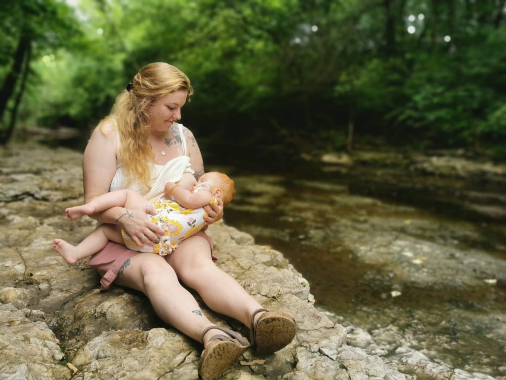 April breastfeeding by a stream during a heatwave