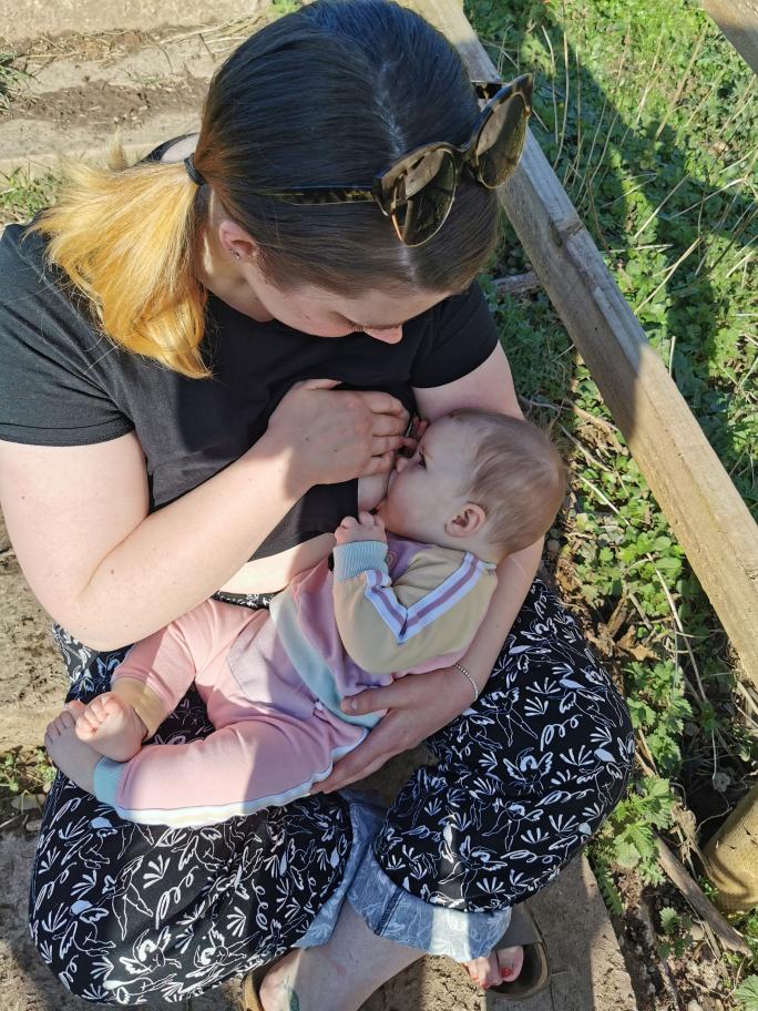 Breastfeeding by a babbling river
