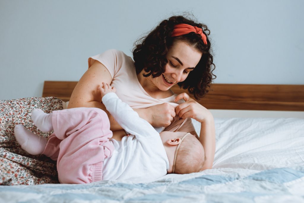 Breastfeeding and ultra-processed foot intake - image of mother breastfeeding infant on bed