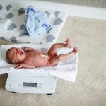 newborn baby getting weighed