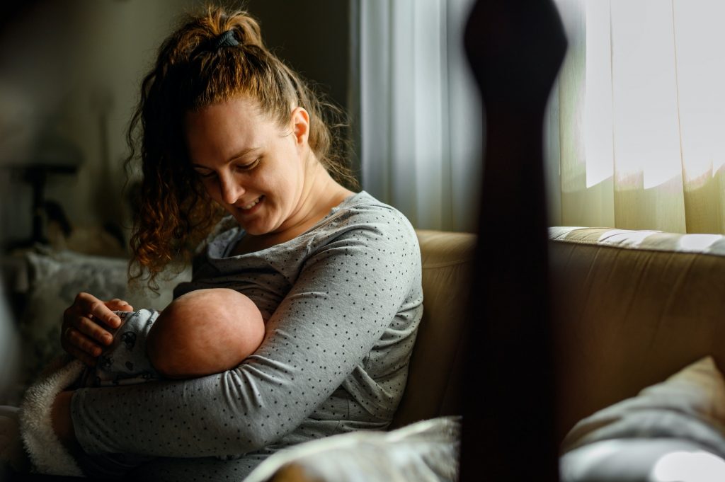 Mother breastfeeding her baby boy