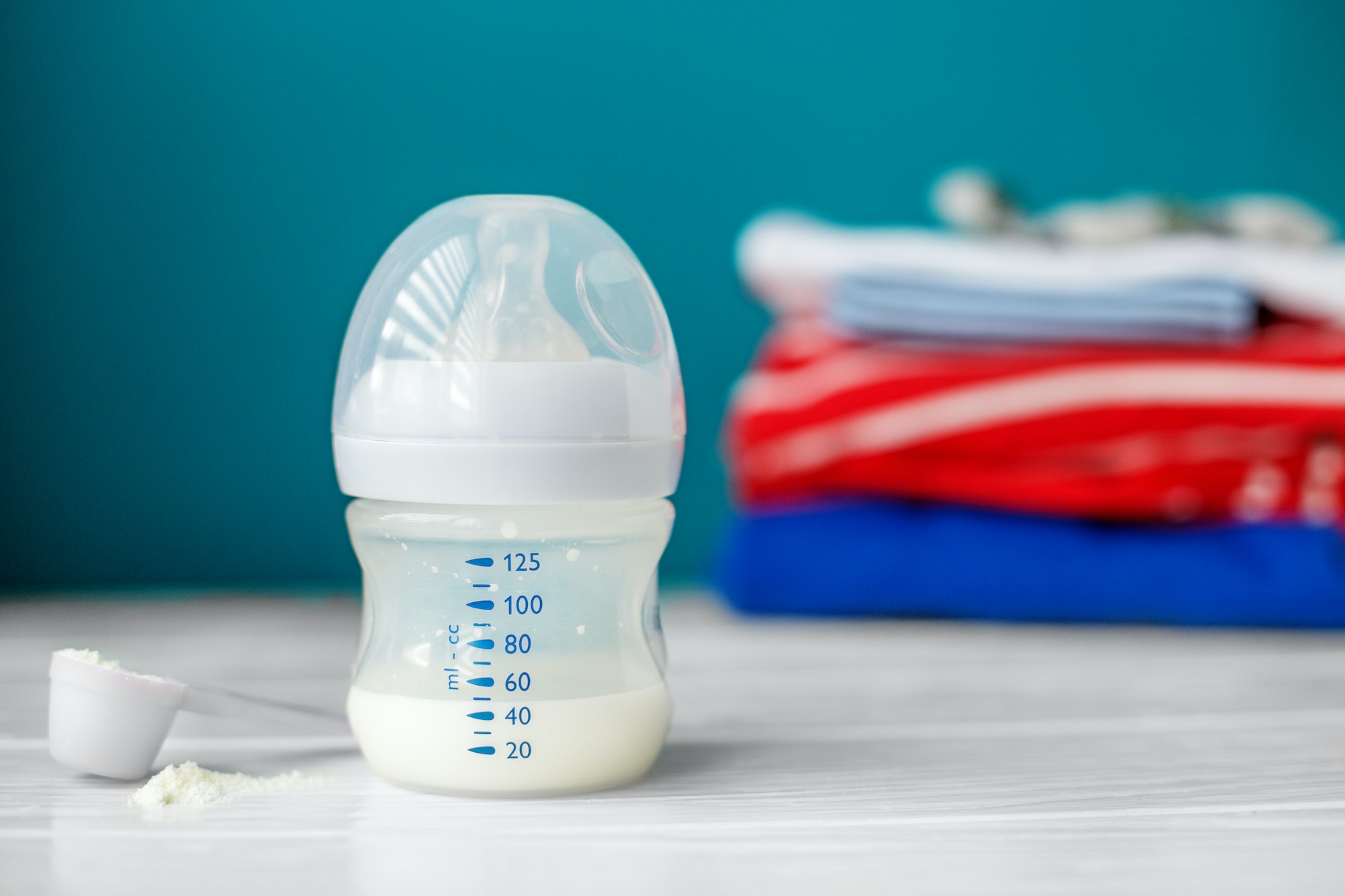 Nutrition for infant in a plastic bottle. Concept of newborns, motherhood, care, lifestyle.