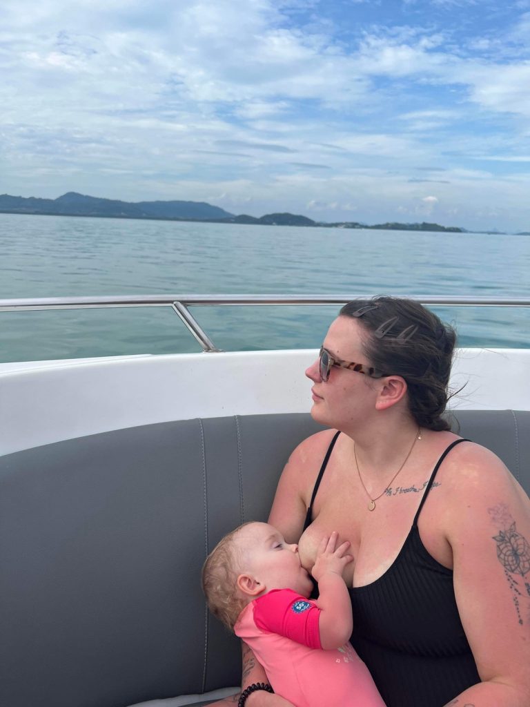 Natalie breastfeeding her baby on a boat