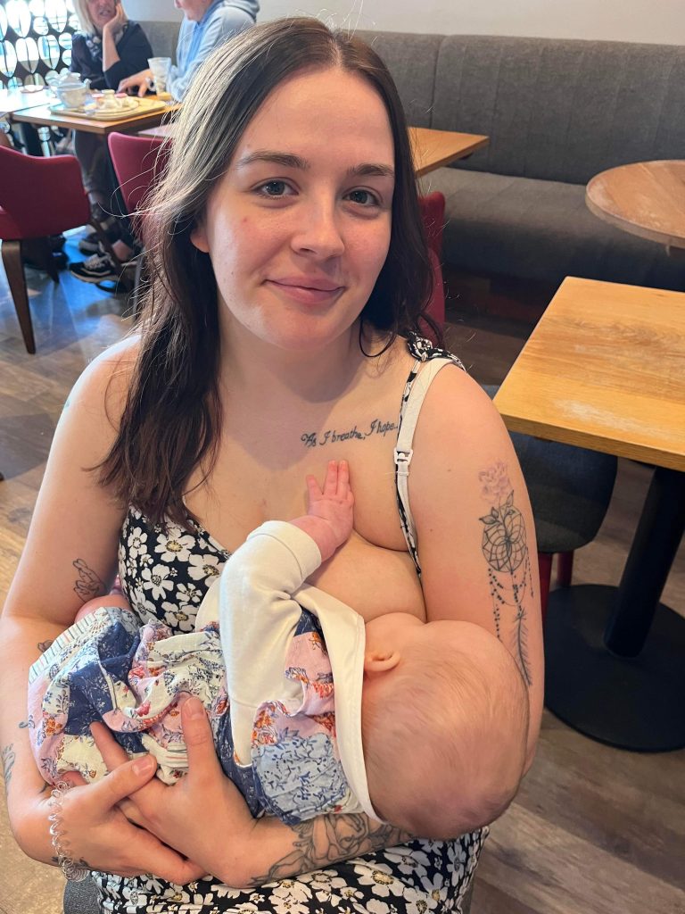 Natalies breastfeeding her baby in a cafe