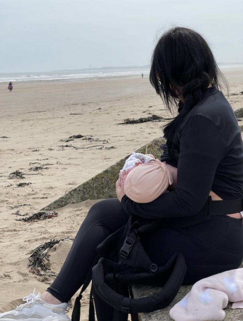 Gemma breastfeeding at Bamburgh beach