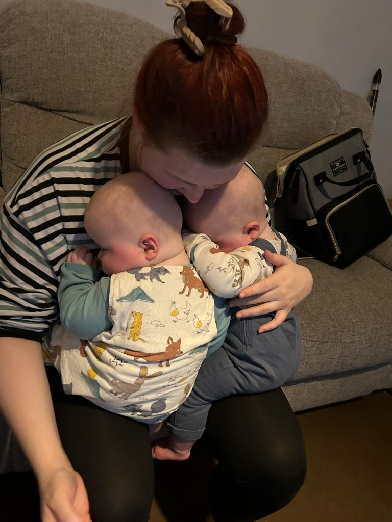 Sian snuggling her twin boys on her lap