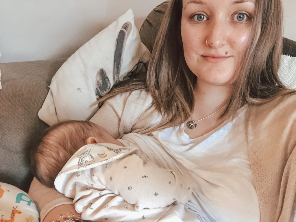 Andrea breastfeeding newborn baby daughter