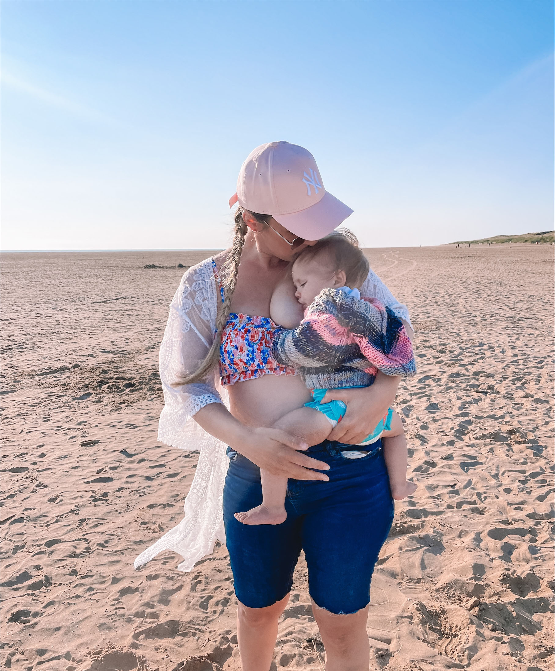 Breastfeeding toddler on the beach