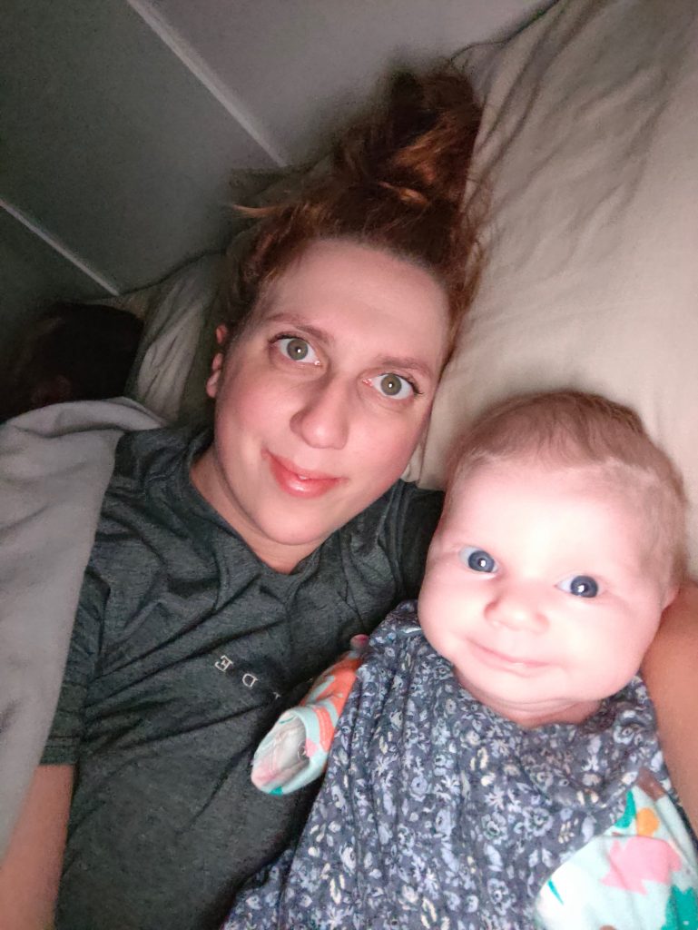sick breastfeeding mama with baby