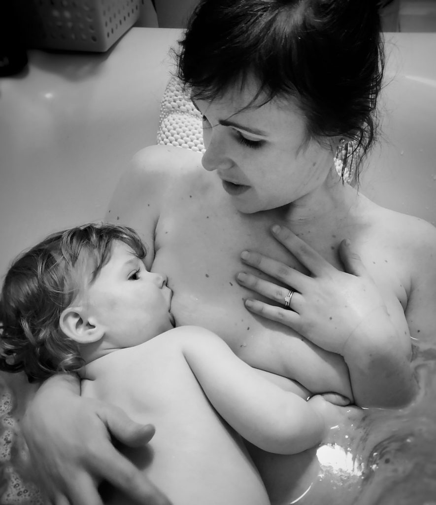 Megan Conran-Turner breastfeeding son in the bath