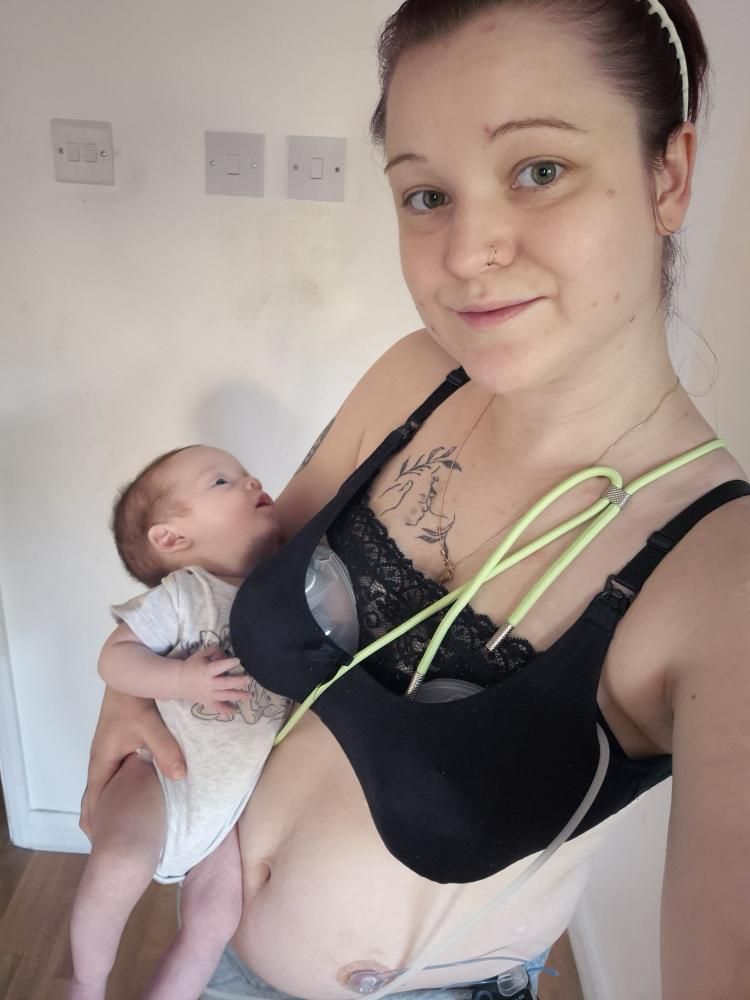 Sophie using an Ardo breast pump whilst holding her baby