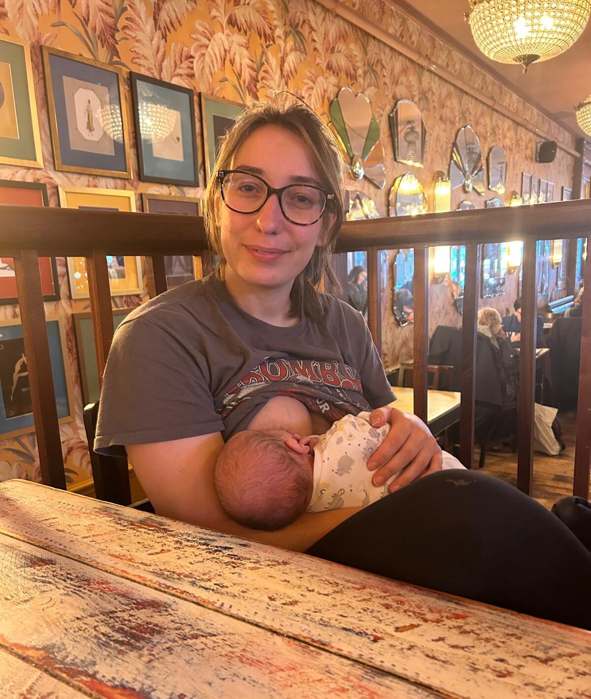 Nicole breastfeeding her son in public space
