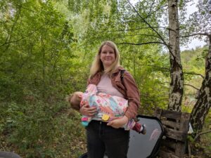 Terri breastfeeding her toddler daughter on a nature walk