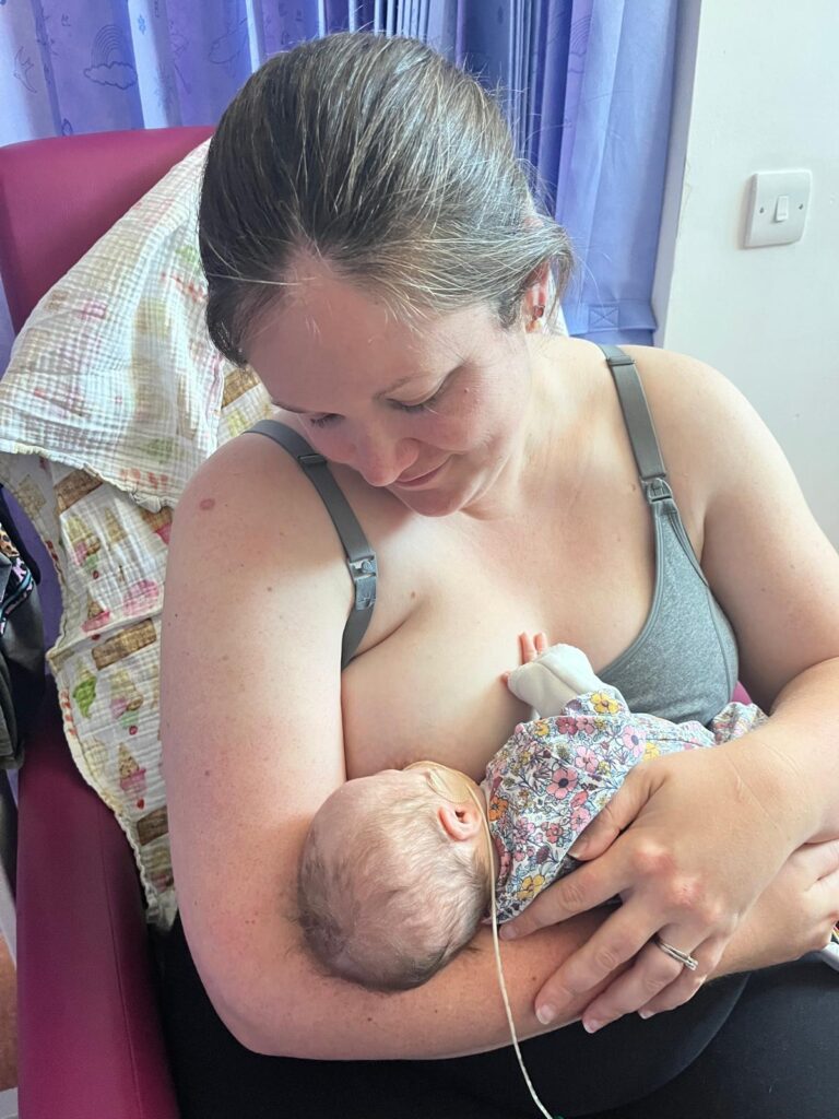 Natalie breastfeeding baby Ivy with Down syndrome