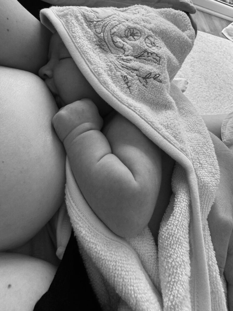 baby bluebelle breastfeeding in hooded towel