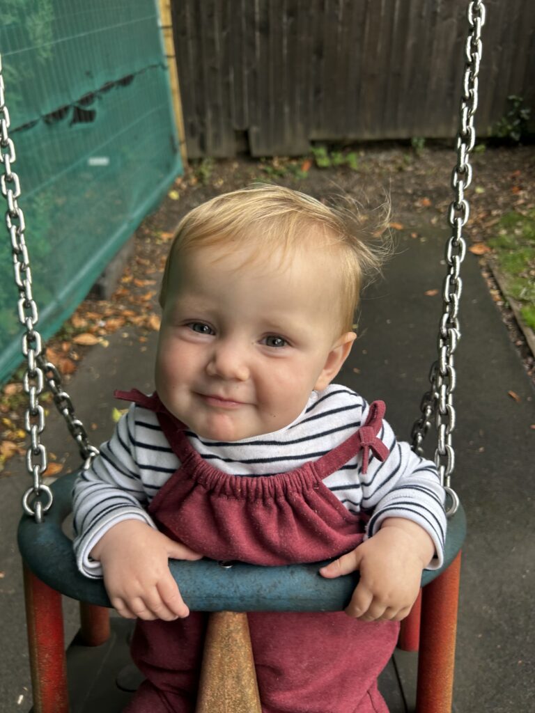 Terri's toddler daughter in a swing