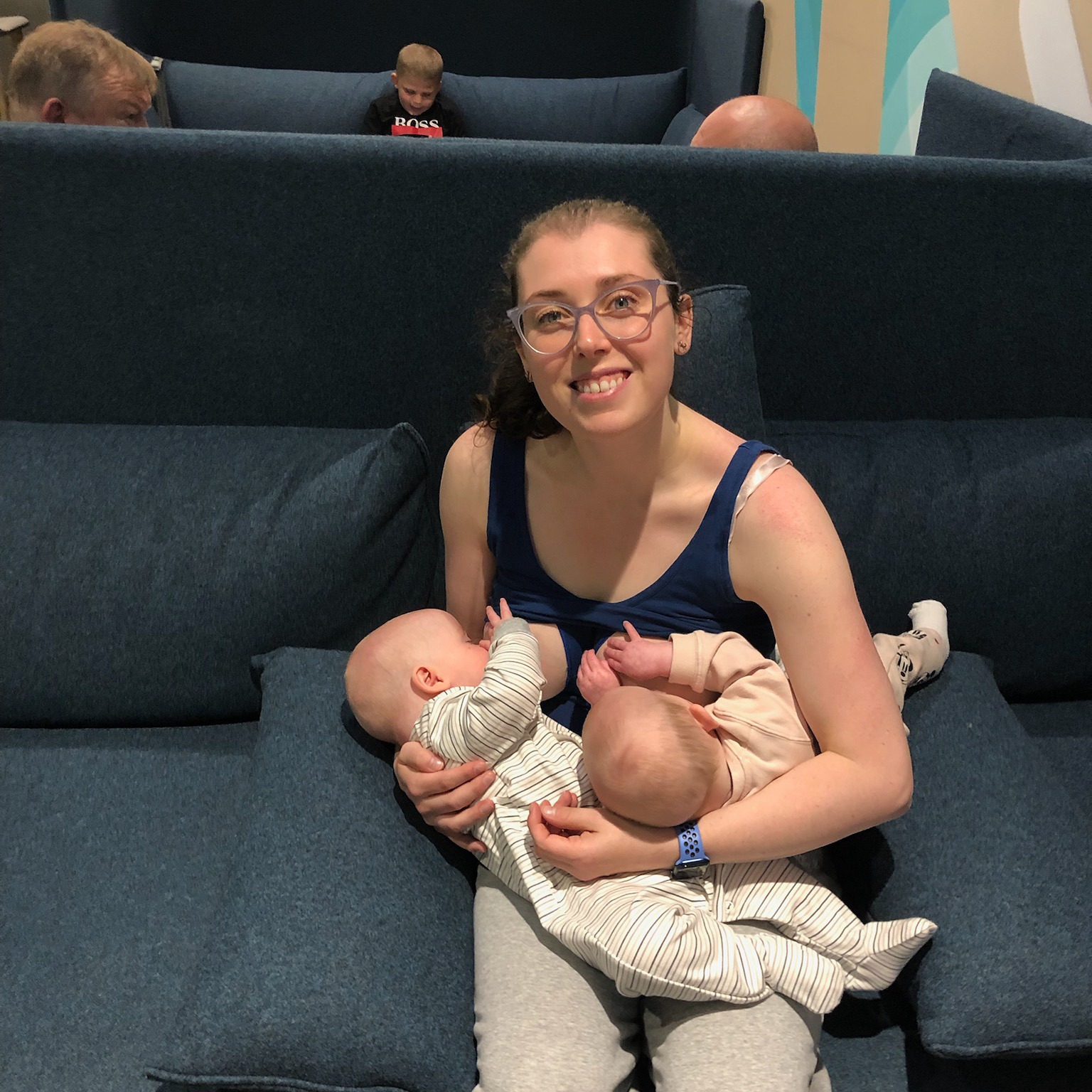 Sarah breastfeeding her twins on a sofa