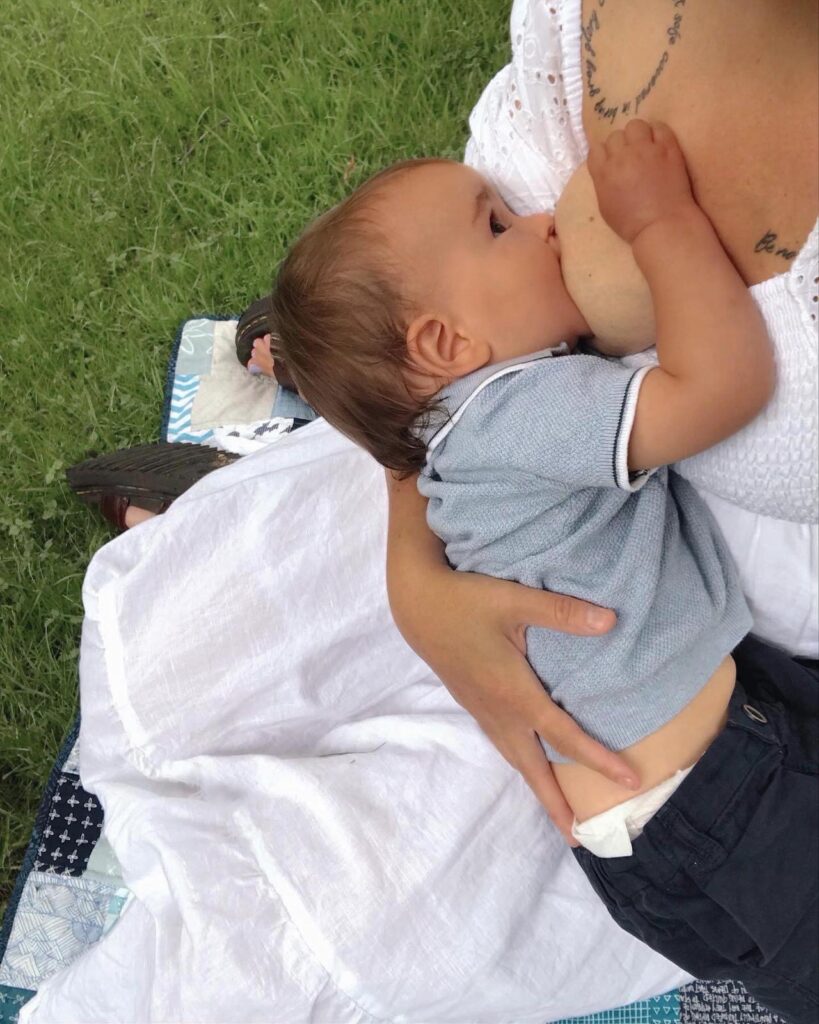 Colette Myers breastfeeding infant son outside on the grass